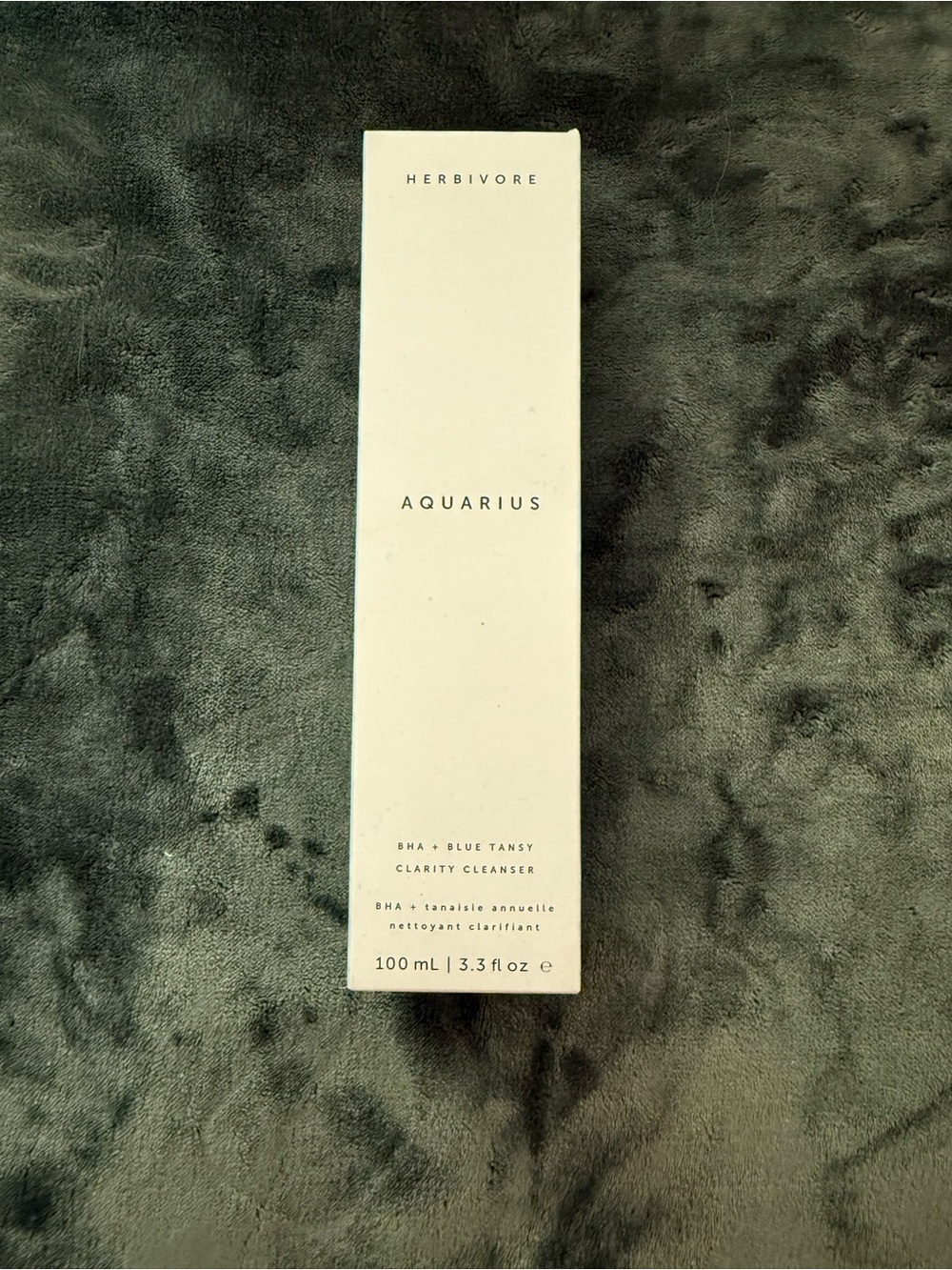 Herbivore Botanicals Aquarius Cleanser - White Box on Dark Gray Surface